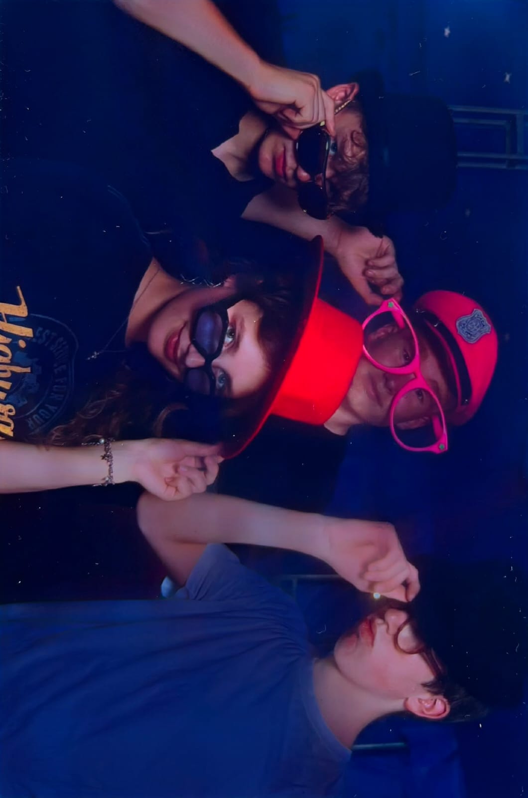The band hanging out together in hats and sunglasses before a show